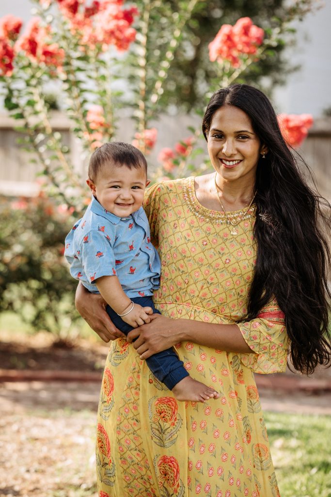 Preethi holding her son representing the food and fitness lifestyle