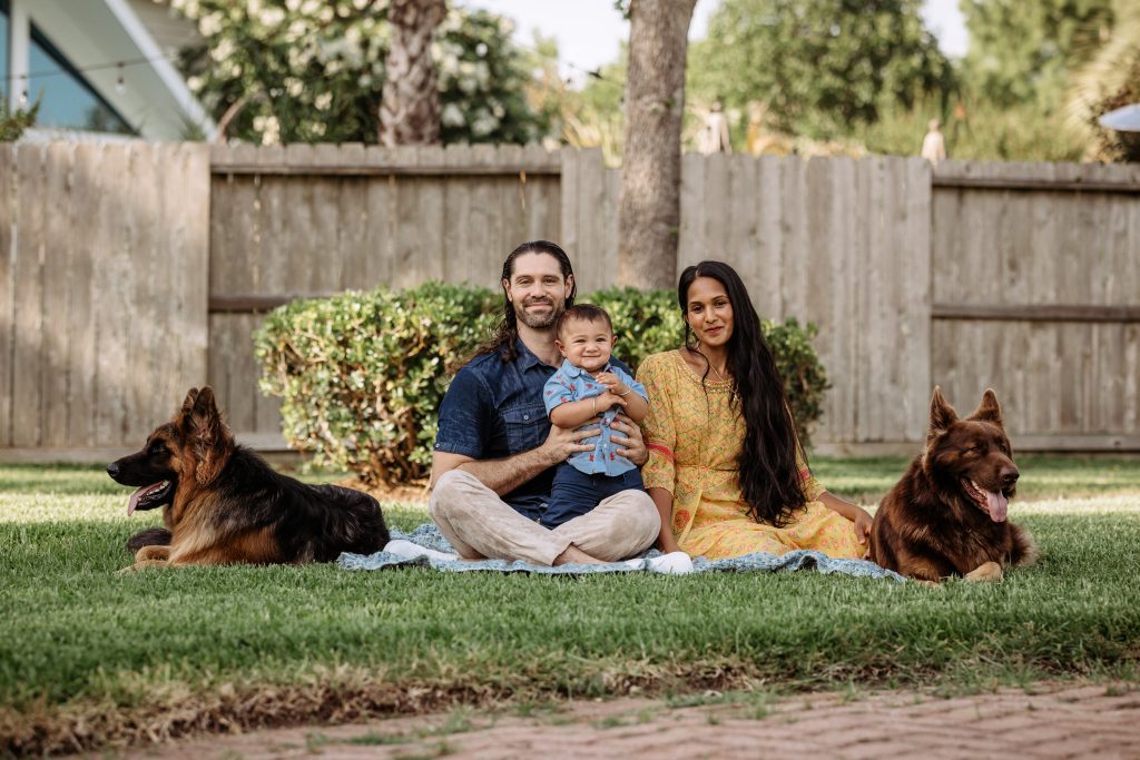 Preethi with her husband, son, and two German Sheperds representing the food and fitness lifestyle
