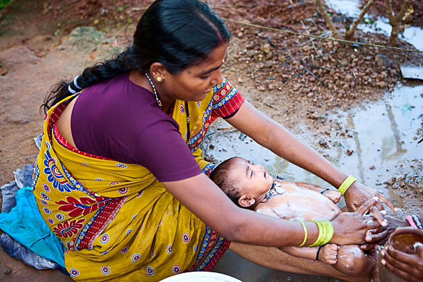 Indian women washing baby